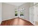 Inviting room with wood floors, arched windows, and a view of the bench outside the home at 6744 Hickory Hammock Cir, Bradenton, FL 34202