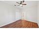 Bedroom showcasing wood floors, ceiling fan, closet, and a doorway to a bathroom at 6744 Hickory Hammock Cir, Bradenton, FL 34202
