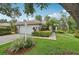 Charming home featuring a well-manicured lawn and inviting landscape at 6744 Hickory Hammock Cir, Bradenton, FL 34202