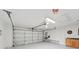Spacious garage with updated lighting, an automatic door and workbench with upper and lower cabinets at 6744 Hickory Hammock Cir, Bradenton, FL 34202