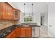 Well-equipped kitchen with dark granite countertops and stainless steel dishwasher at 6744 Hickory Hammock Cir, Bradenton, FL 34202
