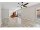 Bright living room with tile floors that lead to a modern kitchen with a breakfast bar at 6744 Hickory Hammock Cir, Bradenton, FL 34202