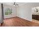 Cozy main bedroom with wood floors, a large window, and an ensuite bathroom at 6744 Hickory Hammock Cir, Bradenton, FL 34202