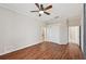 Spacious main bedroom with wood floors, ceiling fan, and ensuite bathroom at 6744 Hickory Hammock Cir, Bradenton, FL 34202