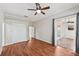 Bright main bedroom features wood floors, ceiling fan, and sliding glass doors to the sunroom at 6744 Hickory Hammock Cir, Bradenton, FL 34202