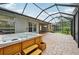 View of screened-in patio with hot tub and tiled floors at 6744 Hickory Hammock Cir, Bradenton, FL 34202