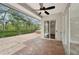 Large screened-in patio with brick flooring, fan, and view of landscaped backyard at 6744 Hickory Hammock Cir, Bradenton, FL 34202