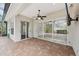 Large screened-in patio with brick flooring, fan, and view of landscaped backyard at 6744 Hickory Hammock Cir, Bradenton, FL 34202