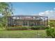 Relax on the screened-in patio featuring a spa tub, providing the ultimate outdoor living and entertaining experience at 6744 Hickory Hammock Cir, Bradenton, FL 34202