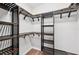 Custom walk-in closet with wooden shelving and ample storage space at 6744 Hickory Hammock Cir, Bradenton, FL 34202