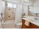 Bathroom features a vanity and a shower-tub combo at 6811 Honeysuckle Trl, Lakewood Ranch, FL 34202