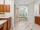 Bathroom featuring dual vanities, a soaking tub, and a walk-in shower with glass door at 6811 Honeysuckle Trl, Lakewood Ranch, FL 34202