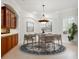 A formal dining area features stylish furnishings and natural light from a window at 6811 Honeysuckle Trl, Lakewood Ranch, FL 34202