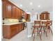 Bright kitchen features stainless steel appliances, a breakfast bar, and tile backsplash at 6811 Honeysuckle Trl, Lakewood Ranch, FL 34202
