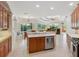 Modern kitchen with a center island, stainless appliances, and views into the living space at 6811 Honeysuckle Trl, Lakewood Ranch, FL 34202