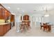 Open kitchen and dining area features wood cabinetry and bar seating at 6811 Honeysuckle Trl, Lakewood Ranch, FL 34202