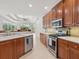 Well-lit kitchen featuring wooden cabinetry, stainless steel appliances, and an eat-in breakfast area at 6811 Honeysuckle Trl, Lakewood Ranch, FL 34202