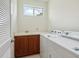 Laundry room with washer, dryer, sink and cabinetry at 6811 Honeysuckle Trl, Lakewood Ranch, FL 34202