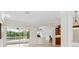 Open-concept space with sliding glass doors, tile floors, and views of the pool and outdoor area at 6811 Honeysuckle Trl, Lakewood Ranch, FL 34202