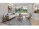 Comfortable living room with a view to the pool, stylish furniture, and ample natural light at 6811 Honeysuckle Trl, Lakewood Ranch, FL 34202