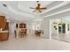 Open-concept living space with kitchen, dining area, and sliding doors leading to outdoor pool at 6811 Honeysuckle Trl, Lakewood Ranch, FL 34202