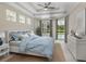 Stylized main bedroom featuring tray ceilings, a view of the pool, and warm, neutral tones at 6811 Honeysuckle Trl, Lakewood Ranch, FL 34202