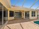 Spacious patio with brick flooring, offering views of the pool and the home's exterior at 6811 Honeysuckle Trl, Lakewood Ranch, FL 34202