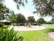 Community playground surrounded by lush greenery, offering a safe and fun space for children to play at 6811 Honeysuckle Trl, Lakewood Ranch, FL 34202