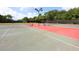 Well-maintained community tennis courts under a clear blue sky with mature trees at 6811 Honeysuckle Trl, Lakewood Ranch, FL 34202