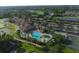Expansive aerial view showcasing community amenities like a pool, tennis courts, clubhouse, and golf course at 7140 Marsh View Ter, Bradenton, FL 34212