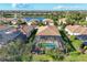 Aerial view of a pool and patio with a screened enclosure, a tranquil lake, and residential neighborhood at 7140 Marsh View Ter, Bradenton, FL 34212