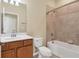 Tiled bathroom featuring a vanity, toilet, and shower-tub combo at 7140 Marsh View Ter, Bradenton, FL 34212