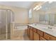 Well-appointed bathroom featuring a soaking tub, glass-enclosed shower, and double vanity at 7140 Marsh View Ter, Bradenton, FL 34212