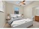 Neutral bedroom featuring tile floors, ceiling fan, ensuite bathroom and stylish furnishings at 7140 Marsh View Ter, Bradenton, FL 34212
