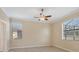 Bright bedroom featuring neutral walls, tile flooring, and two windows at 7140 Marsh View Ter, Bradenton, FL 34212