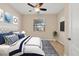 Stylishly furnished bedroom with a ceiling fan, window, and decorative artwork at 7140 Marsh View Ter, Bradenton, FL 34212