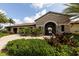 The elegant stone clubhouse entrance features lush landscaping and a beautiful courtyard at 7140 Marsh View Ter, Bradenton, FL 34212