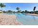 Expansive community pool is surrounded by lounge chairs and tropical landscaping, creating a serene retreat at 7140 Marsh View Ter, Bradenton, FL 34212