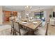 Open-plan dining area adjacent to the kitchen and living area, with abundant natural light and a decorative rug at 7140 Marsh View Ter, Bradenton, FL 34212
