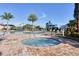 Hot tub surrounded by brick pavers with blue sky, lounge chairs and landscaping at 7140 Marsh View Ter, Bradenton, FL 34212