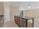 Spacious kitchen featuring an island with a sink and stainless steel dishwasher at 7140 Marsh View Ter, Bradenton, FL 34212