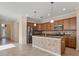 Open concept kitchen with island seating, stainless steel appliances, and tile backsplash at 7140 Marsh View Ter, Bradenton, FL 34212