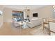 Beautifully furnished living room with comfortable sofas, stylish decor, and a large sliding glass door to the lanai at 7140 Marsh View Ter, Bradenton, FL 34212