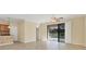 Spacious living room area with tile floors and sliding glass doors leading out to the screened lanai at 7140 Marsh View Ter, Bradenton, FL 34212