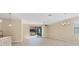 Open living area with tile flooring, large sliding glass doors out to the lanai, and a ceiling fan at 7140 Marsh View Ter, Bradenton, FL 34212