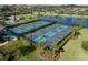 Aerial view of community pickleball courts with lake in background at 7140 Marsh View Ter, Bradenton, FL 34212