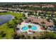 Aerial view of community pool, club house, pool, and lounge chairs at 7140 Marsh View Ter, Bradenton, FL 34212