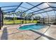 Relaxing screened-in pool and spa area with a view of the backyard at 7140 Marsh View Ter, Bradenton, FL 34212