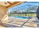 Beautiful screened-in pool and spa area with lush landscaping at 7140 Marsh View Ter, Bradenton, FL 34212