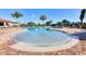 Beautiful zero entry pool with brick pavers, clear blue sky and many lounge chairs at 7140 Marsh View Ter, Bradenton, FL 34212